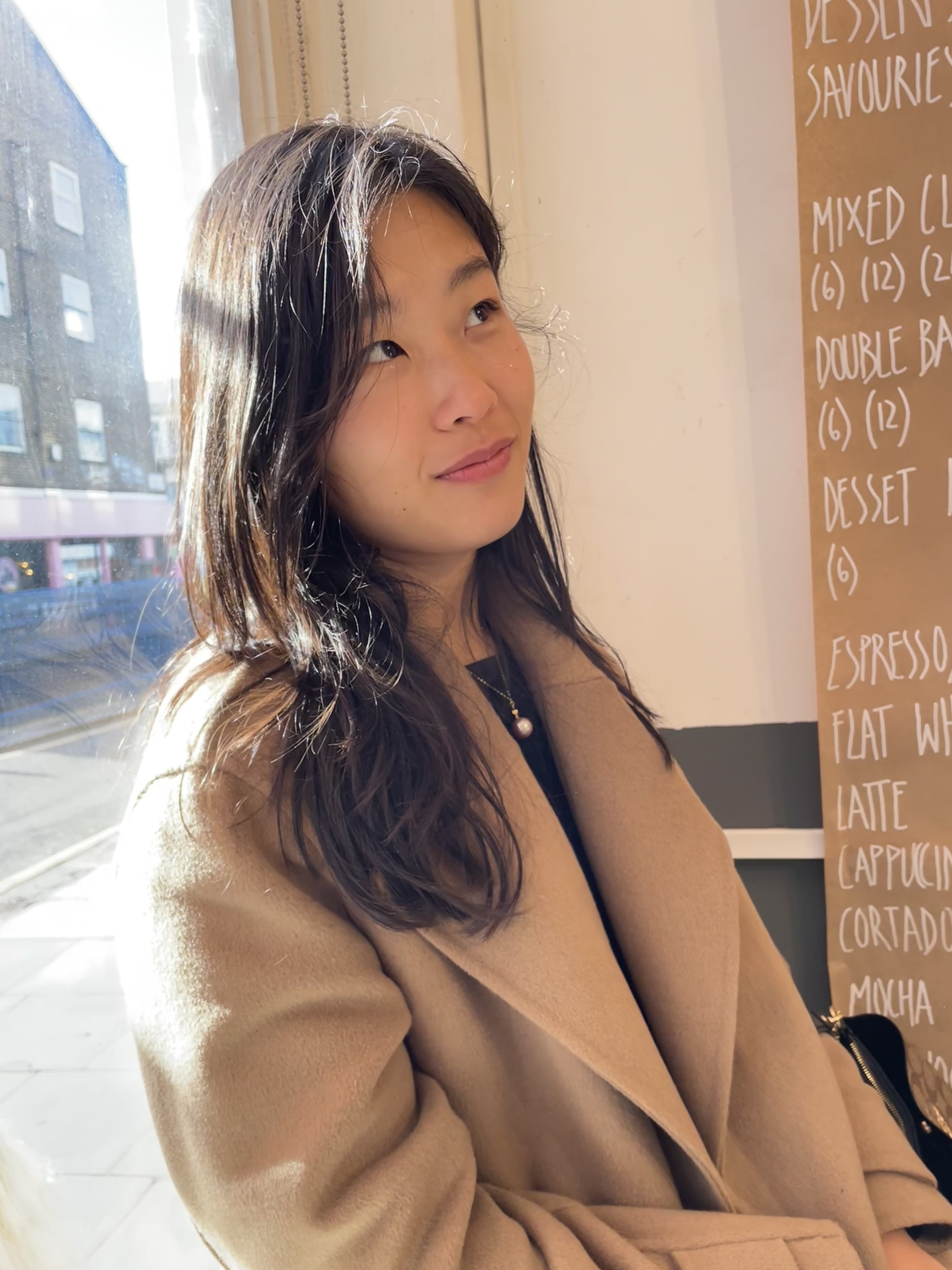 Portrait of the blog owner with face partially distorted through two clear glasses of water on a white table
